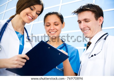 Young doctors working against a hospital building
