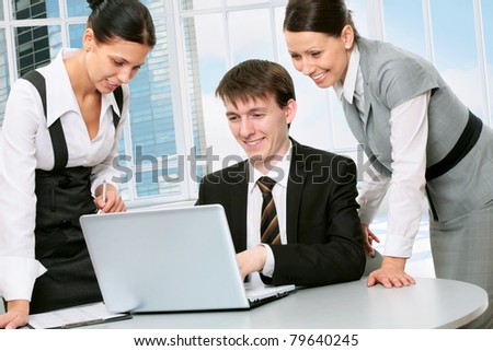 Happy young business people working together in a modern office building