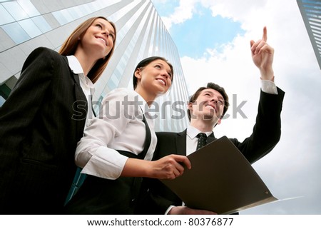Happy business people on the background of a modern office building