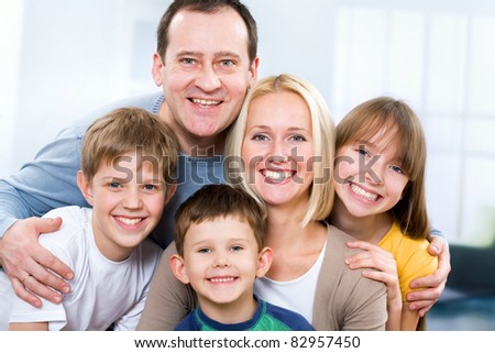 Happy family smiling looking at camera