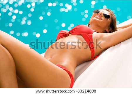 Beautiful big-breasted woman posing in golden bikini top - Stock Image -  Everypixel