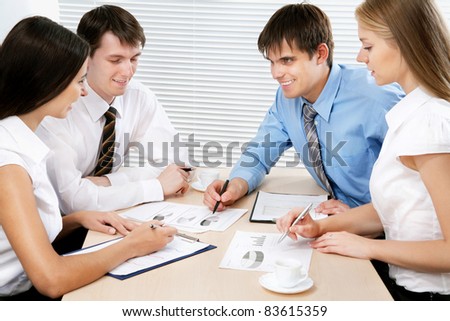 Four business people working together at office
