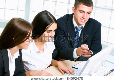 Group of business people looking at computer monitor