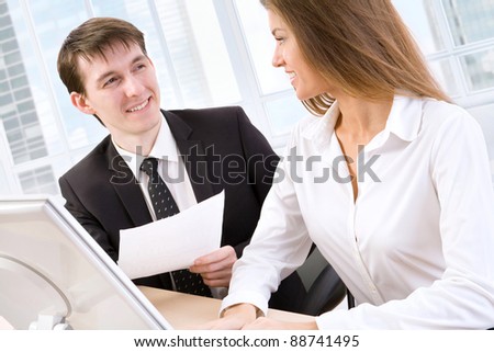 Business man showing something on monitor to his colleague
