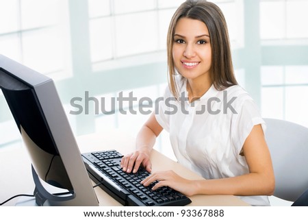 Pretty business woman at office desk