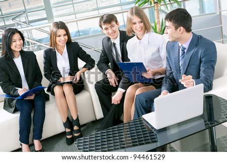 Image of happy business people working at meeting