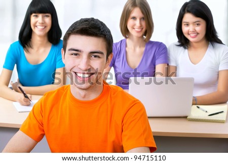Happy young students studying together in a college