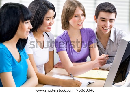 Group of young students studying together in a college - stock photo