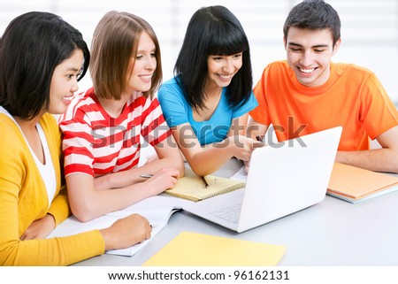 Young students studying together with laptop