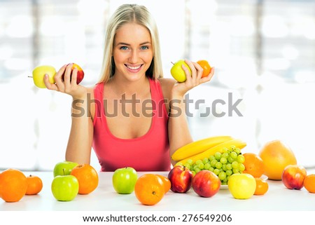 Smiling pretty woman with fruits