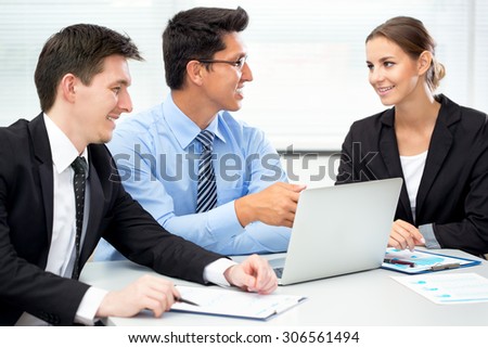 Group of happy businesspeople in a meeting at office