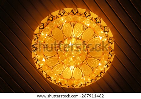 Beautiful Indoor Lighting Chandelier on ceiling with textured background
