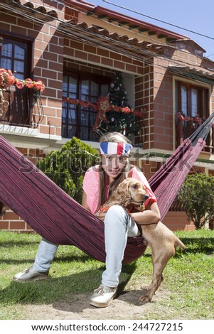 Woman sitting in the hammock with dog