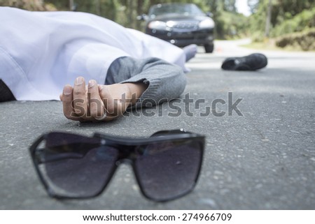 dead man lying in the street, car accident