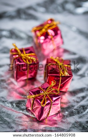 Red decorative gifts on silver background