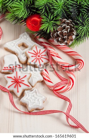Christmas cookies in a white and red glaze on a white wooden background