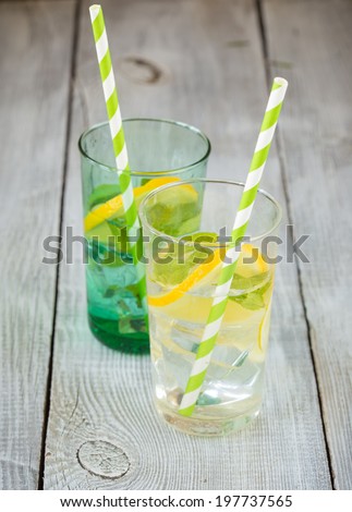 Two glasses of lemonade and colored paper straws