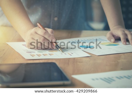 businessgirl working on Desk office business financial accounting calculate, Graph analysis, vintage color