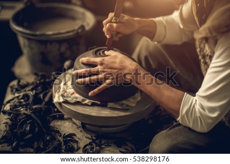 Craftsman artist making craft, pottery, sculptor from fresh wet clay on pottery wheel, selected focus
