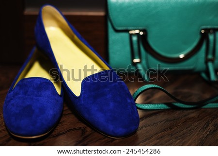 Fashion female feet wear, clutch bag de-focused behind