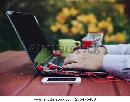 Freelance or remote work concept - male is using laptop computer.