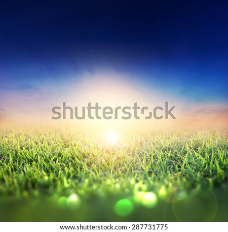 blurry of Green Field and bokeh with Beautiful twilight sky and Sunset