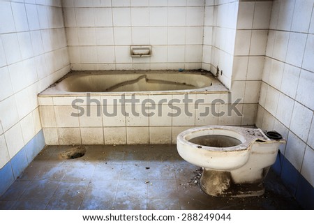Broken old abandoned dirty toilet bowl