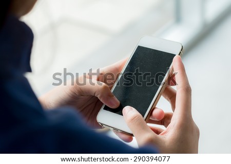 Close up of business woman handing smartphone.