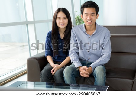 Smiling Business people sitting on sofa in office