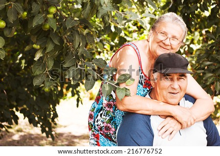 Elderly couple. Happy family. Pensioners. Cherry garden