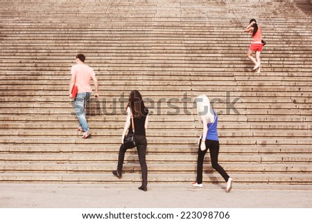 Pedestrians on stairs. People go to work. Career ladder. City street