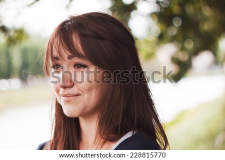 Girl cries and smiles. Puffy eyes. Emotional portrait of beautiful brunette. Depression, sadness, loneliness