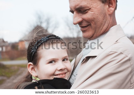 Uncle and niece. Emotional portrait of hugging relatives. Positive emotions, joy and laughter