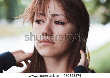 Girl cries. Puffy eyes. Emotional portrait of beautiful brunette. Depression, sadness, loneliness