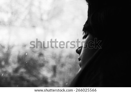 Girl sleeping in train. Portrait of beautiful brunette. Journey by rail. Fall outside window. Black and white photo