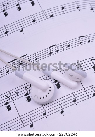 earbuds on the sheet music