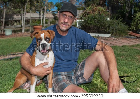 Boxer puppy and man with big smiles.