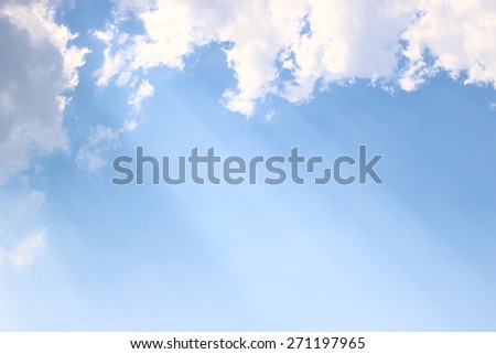Light through clouds with blue sky background, spiritual image