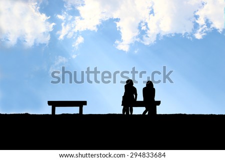 The silhouette of two friend sitting together with light through clouds background, concept of real friend needed, being friend