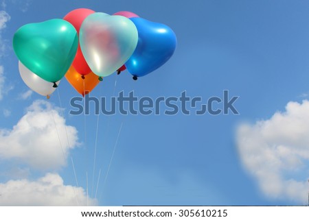 The colorful heart-shaped balloons with blue sky background