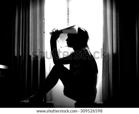 The silhouette of stressed and depressed woman worried about her studies in black and white