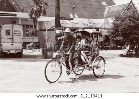 Tricycle bicycle taxi for local people and tourists on April 13, 2015 in Nan,Thailand. Tricycle bicycle taxi is one of the public  and old transport in Thailand.