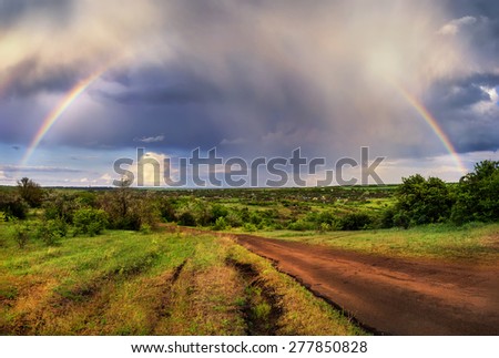 Rainbow on a background of the spring landscape