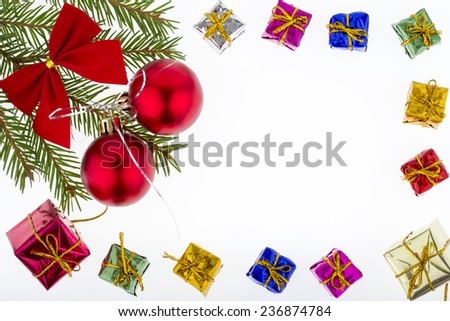 Christmas decoration - red globes, red bow, colorful gifts and fir twig on white background