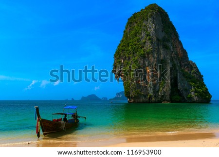 Travel landscape, beach with blue water and sky at summer. Thailand nature beautiful island and traditional wooden boat. Scenery tropical paradise resort.