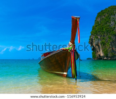Travel landscape, beach with blue water and sky at summer. Thailand nature beautiful island and traditional wooden boat. Scenery tropical paradise resort.