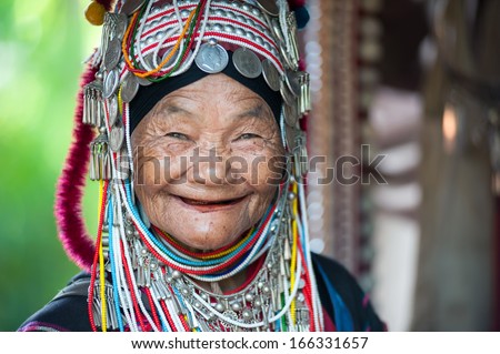 CHIANG RAI THAILAND DEC 4 Unidentified Akha tribe elderly woman with traditional clothes and silver jewelery in hill tribe minority village on December 4 2013 Mae Hong Son Thailand CHIANG RAI THAILAND DEC 4 Unidentified Akha tribe elderly woman with traditional clothes and silver jewelery in hill tribe minority village on December 4 2013 Mae Hong Son Thailand