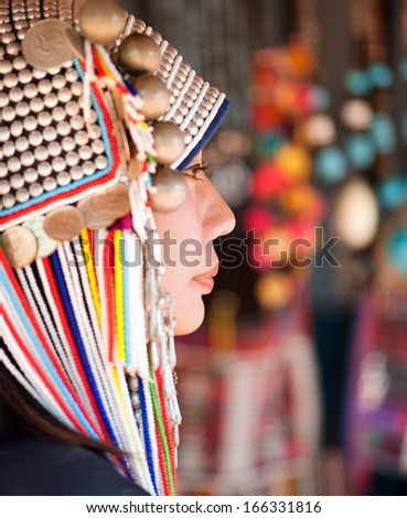 CHIANG RAI, THAILAND - DEC 4 : Akha girl with traditional clothes and silver jewelery in akha hitt tribe minority village on December 4, 2013 in Chiang Rai, Thailand.