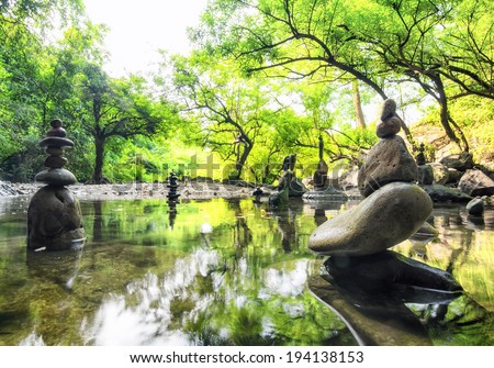 Zen pond in forest. Photography of stone towers, peace and calm concept