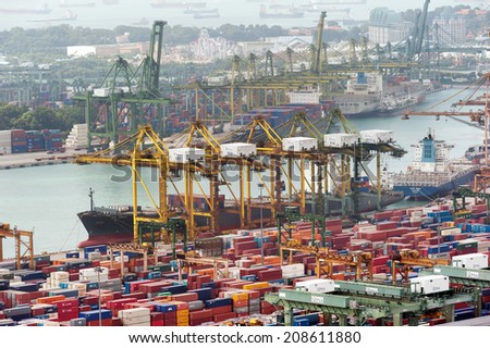 SINGAPORE - 2 JAN, 2014: Commercial port of Singapore. Cargo ships loading and unloading containers in industrial port. One of most important warehouses and trade docks for economy of Asia